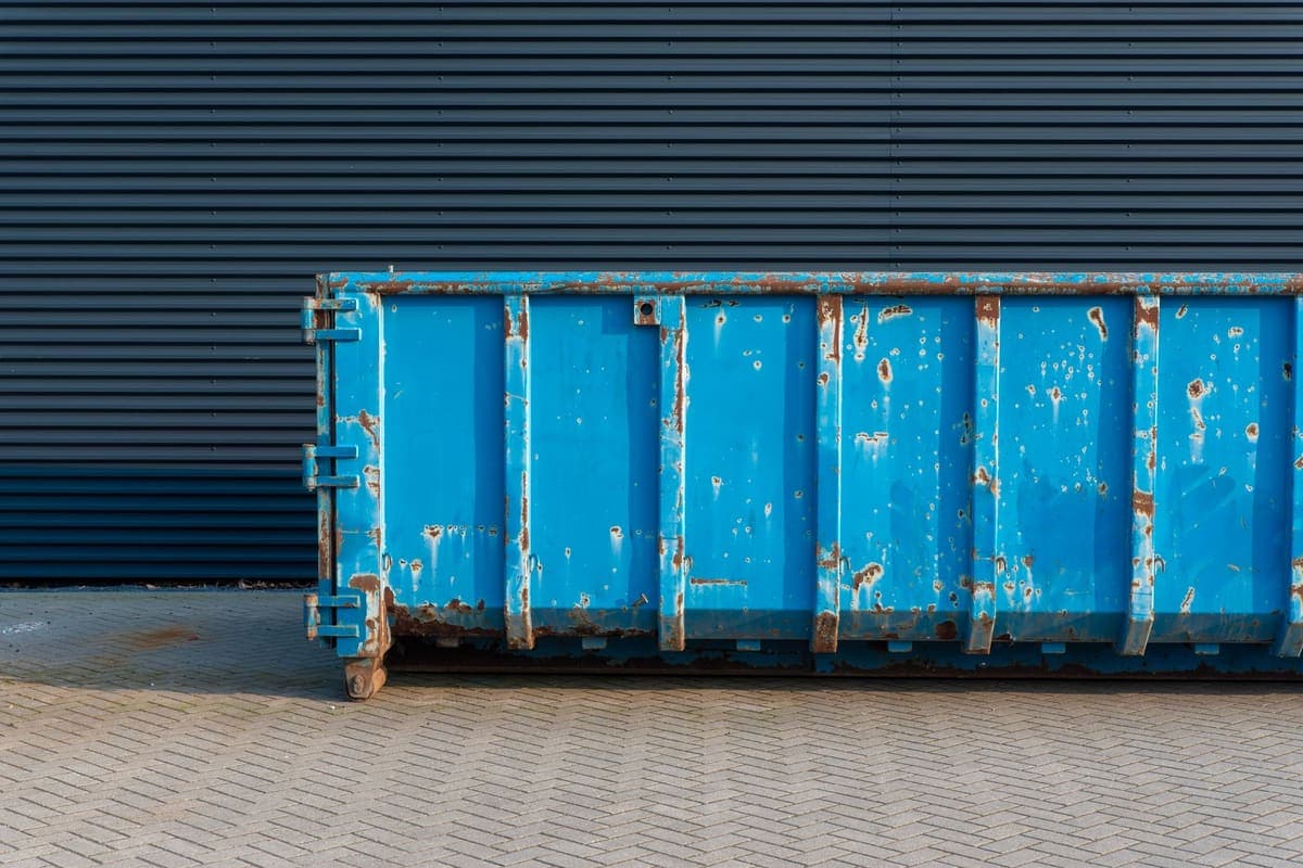 Large wheeled waste container standing outdoors