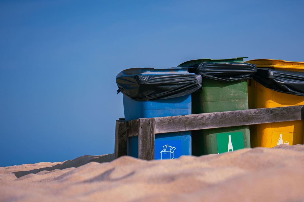 Large waste bins with black liners folded over their rims