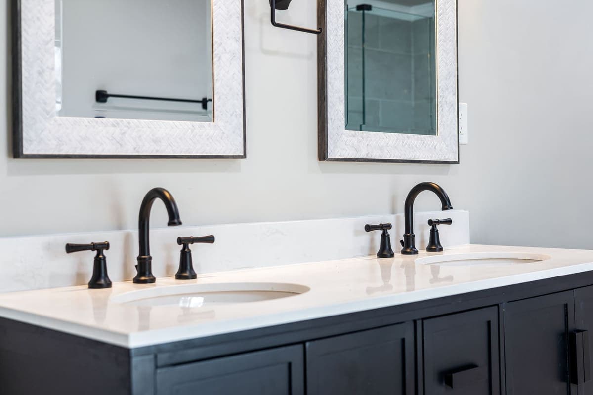 Double vanity in a bright bathroom with black fixtures