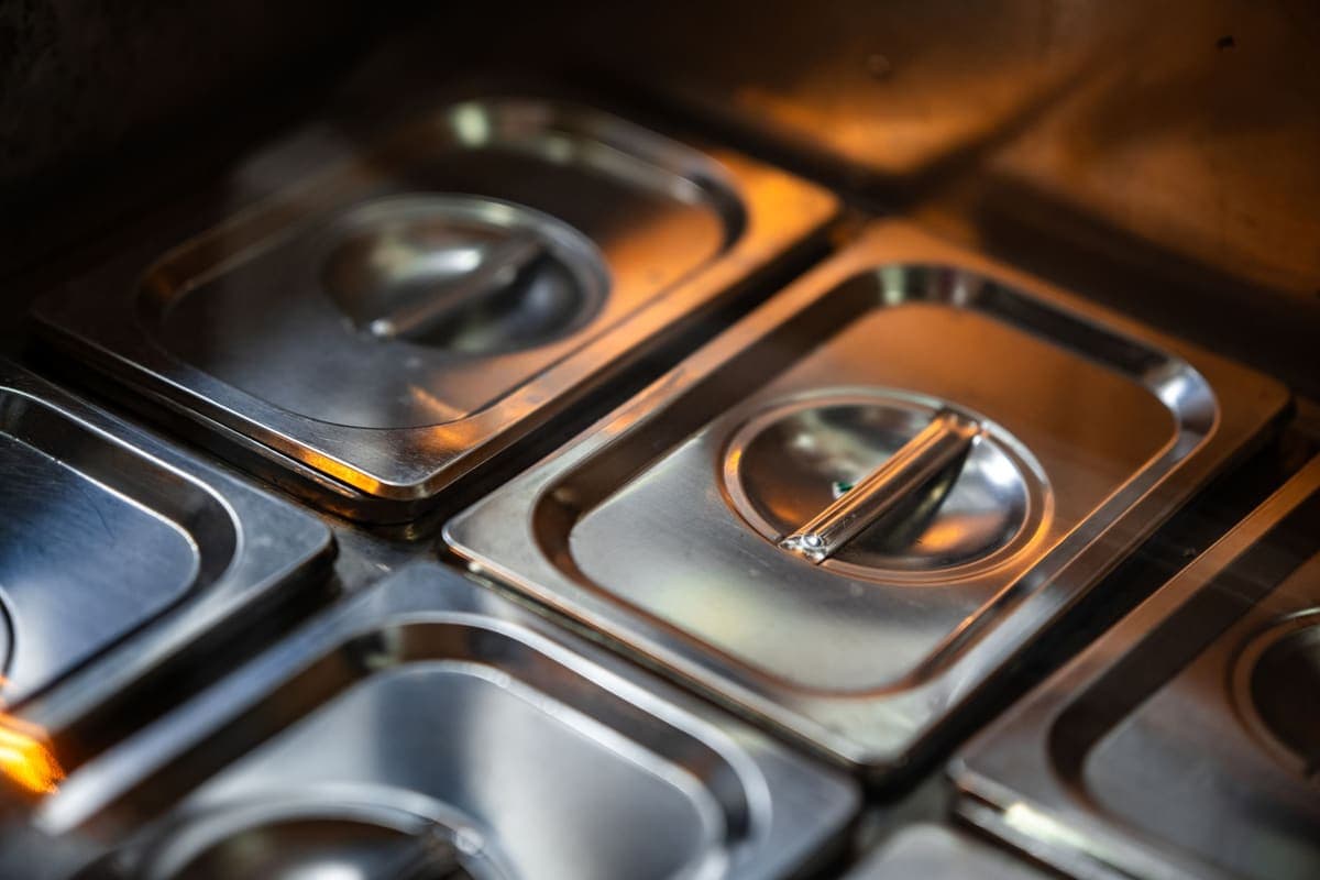 Brushed stainless steel surfaces and lids in a kitchen