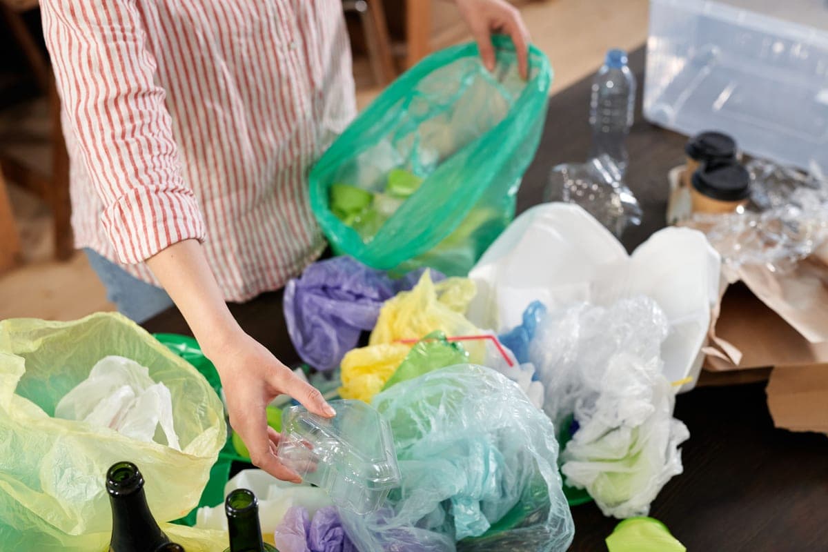 Full kitchen trash bag inside a can