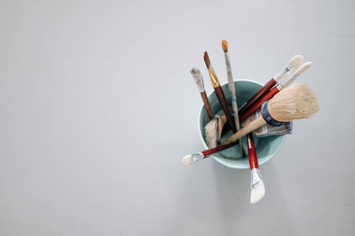 Cleaning brushes in a container on a wall