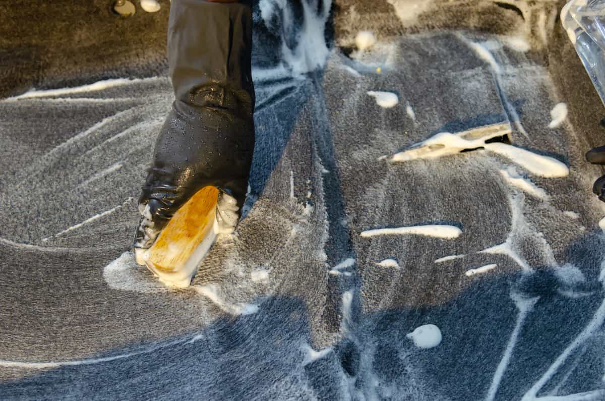 Scrubbing brush in soapy water