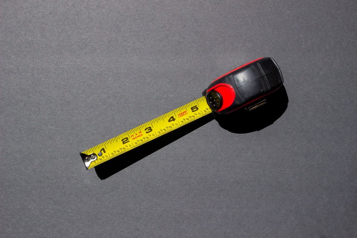 Tape measure being used to measure an object