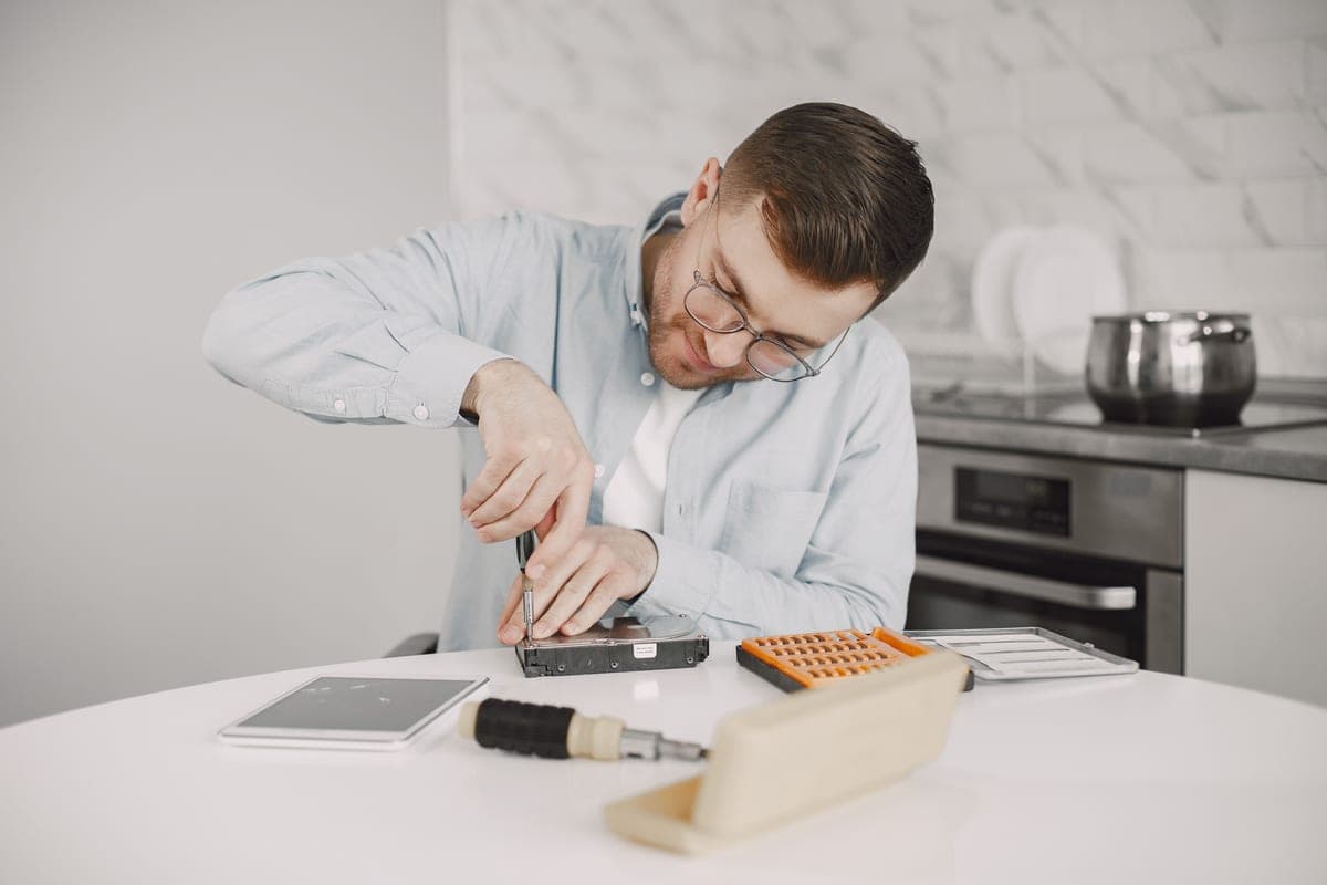 Screwdriver being used to repair an appliance