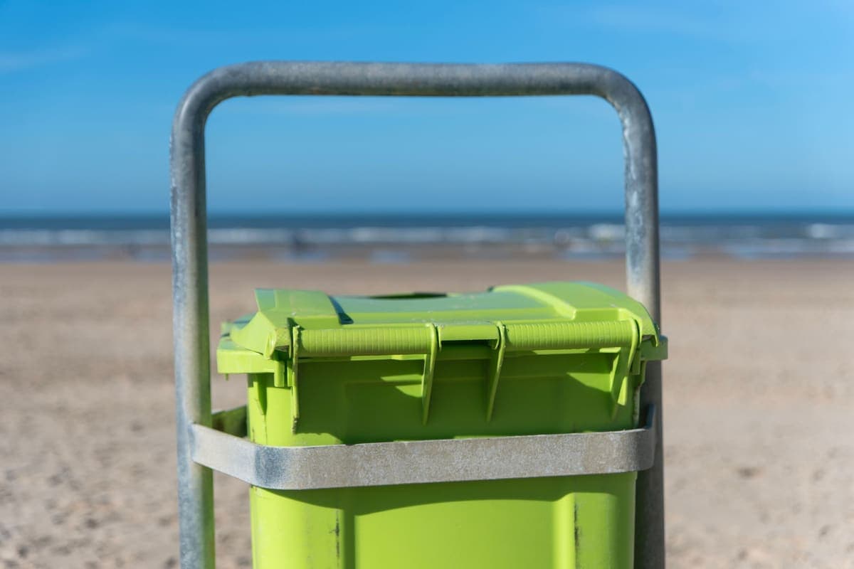 A wheeled garbage bin with its lid closed