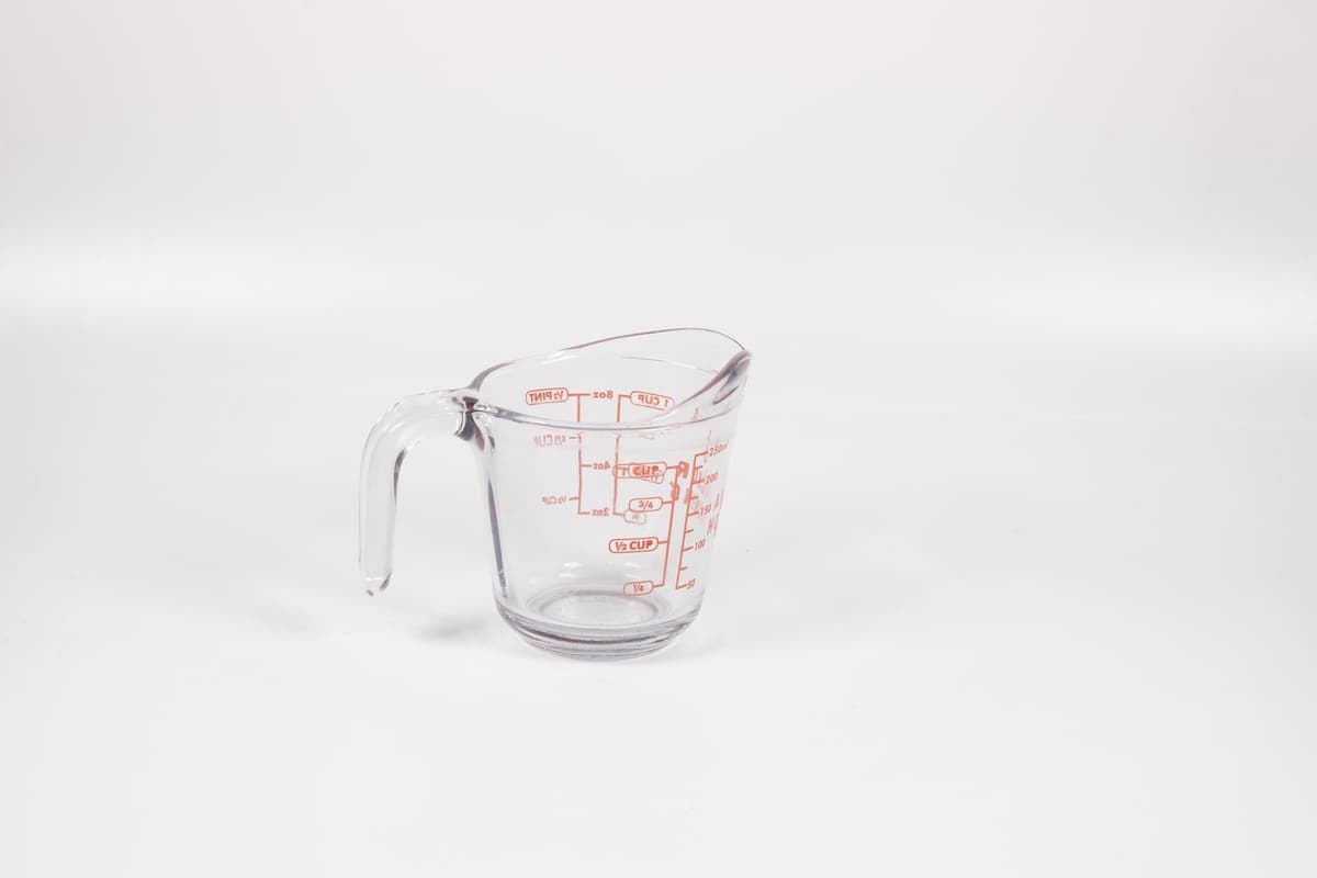 A glass measuring jug with imperial and metric graduations