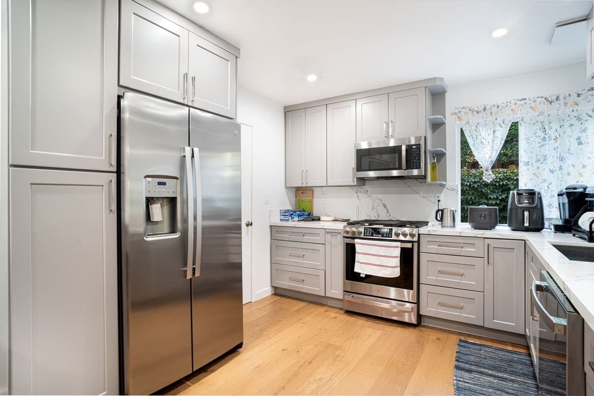 Kitchen with stainless steel appliances and gray cabinets
