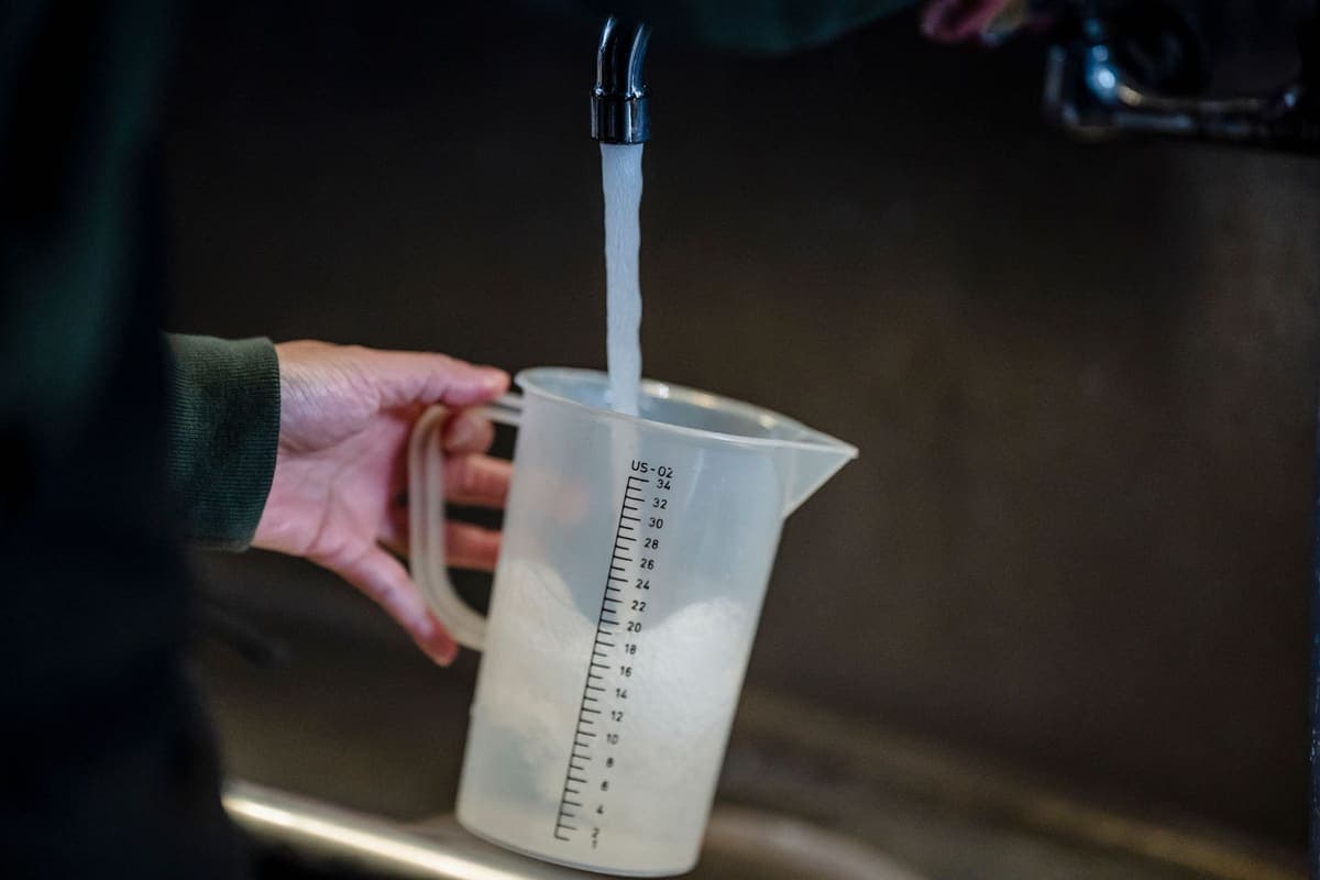 Clear measuring jug being filled with water