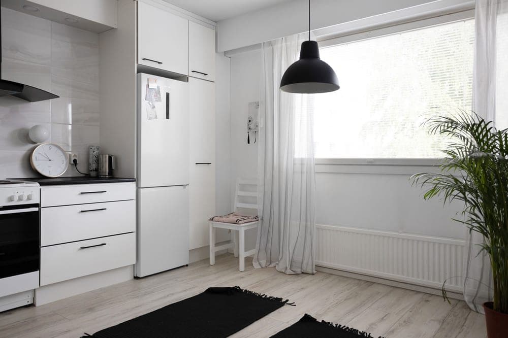Stainless steel automatic trash can in a kitchen