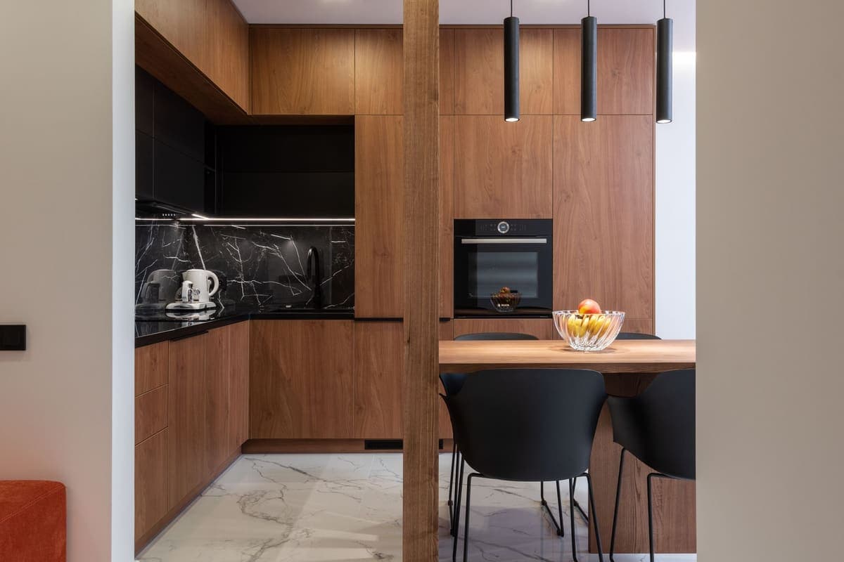 A compact kitchen with full-height wood cabinetry