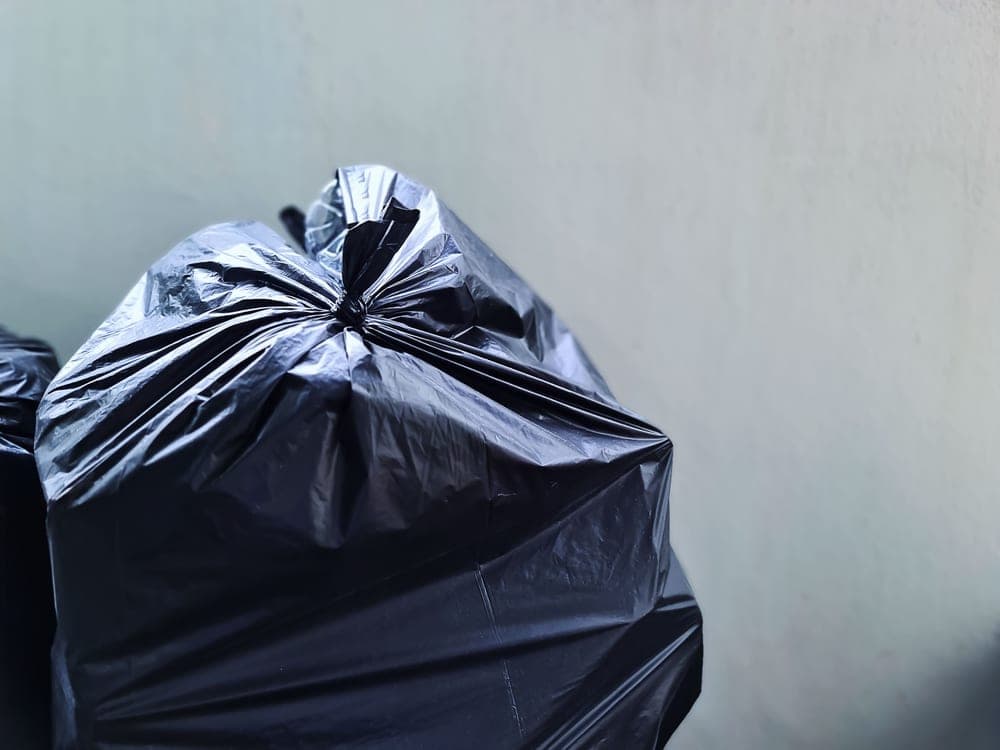 Roll of black tall kitchen drawstring trash bags