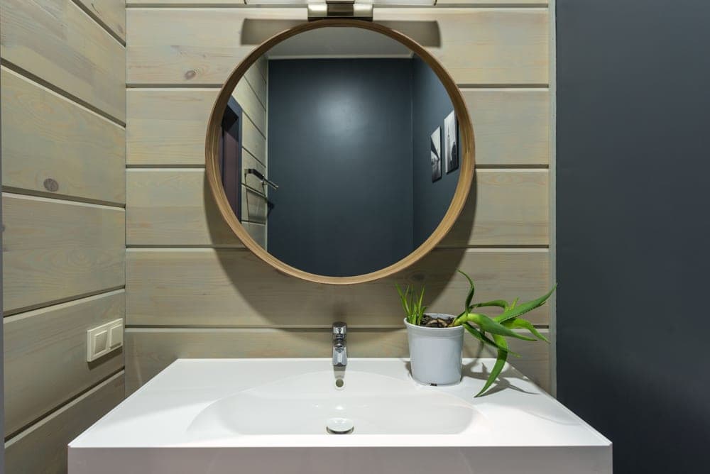 Slim rectangular bathroom wastebasket beside a sink