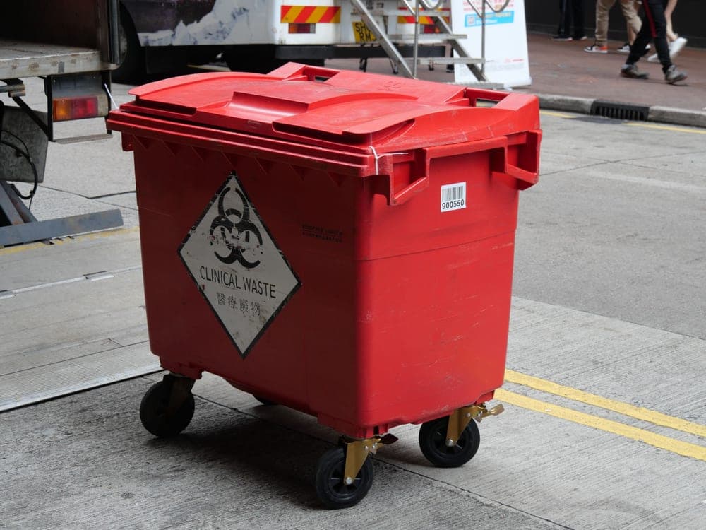 Two-wheel rolling outdoor trash cart at the curb