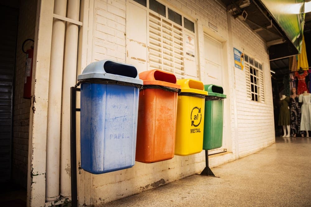 Wicker-style resin outdoor trash container on a patio