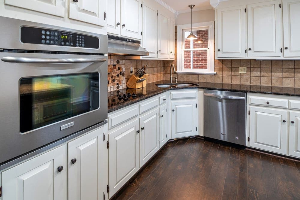 Pull-out trash and recycling bins inside a kitchen cabinet